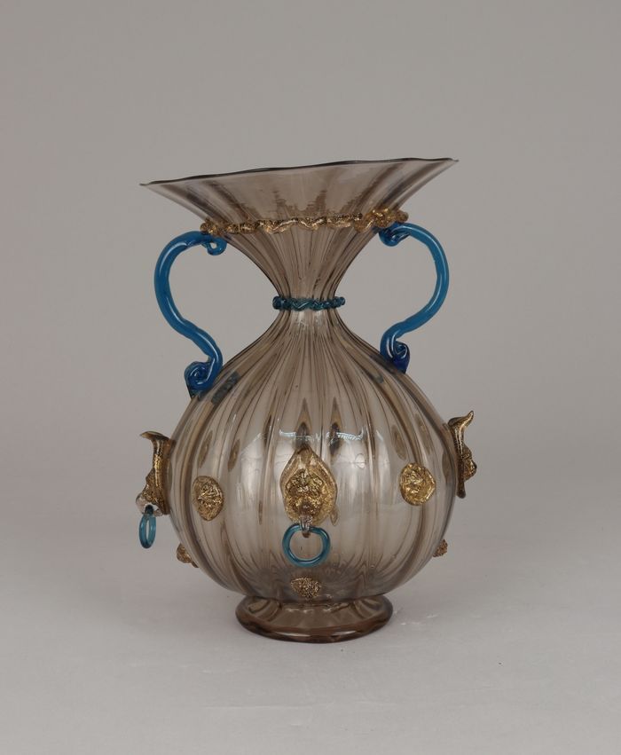 Ribbed and fluted vase with lion masks