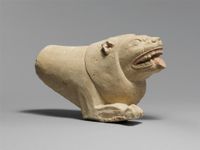 Bone lion's head protome with glass eyes