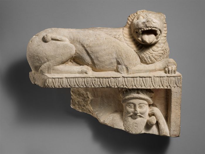 Limestone finial of a funerary stele with a recumbent lion and a banquet scene