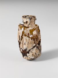 Limestone finial of a funerary stele with a recumbent lion and a banquet scene