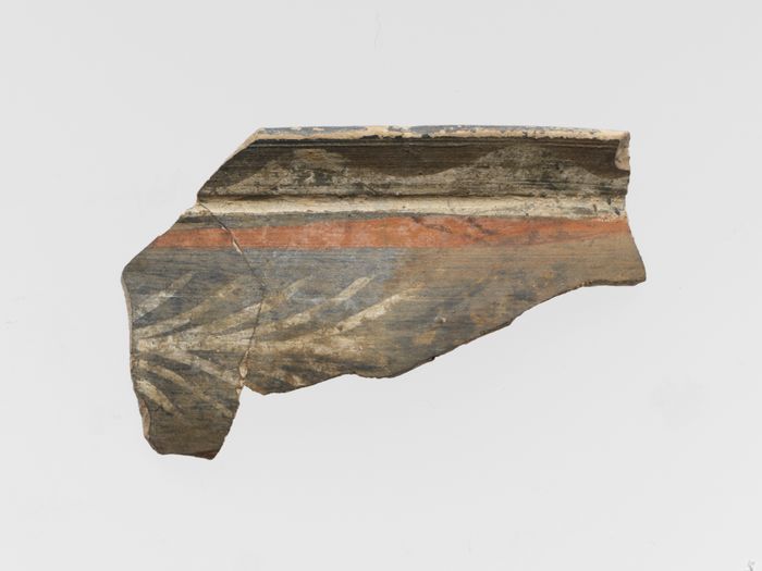 Terracotta rim of a cup with fern pattern and bands
