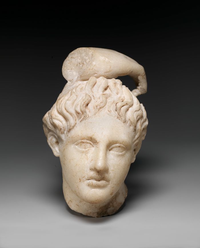Marble head of Apollo with fragment of his hand