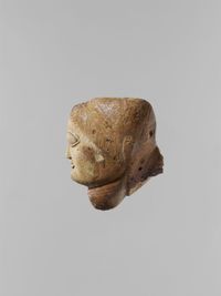 Glass pendant in the form of a demonic mask